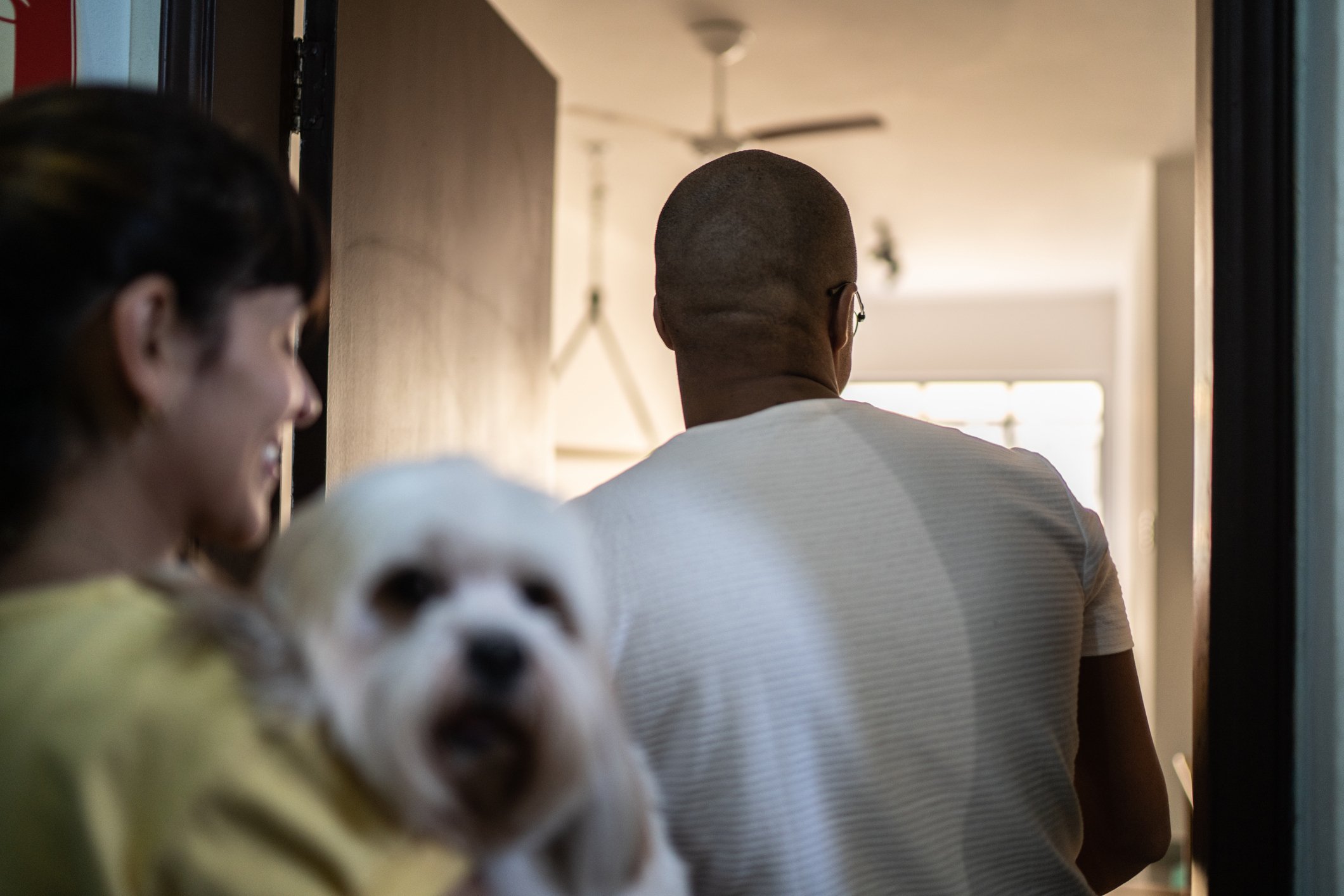 Young couple entering home with dog